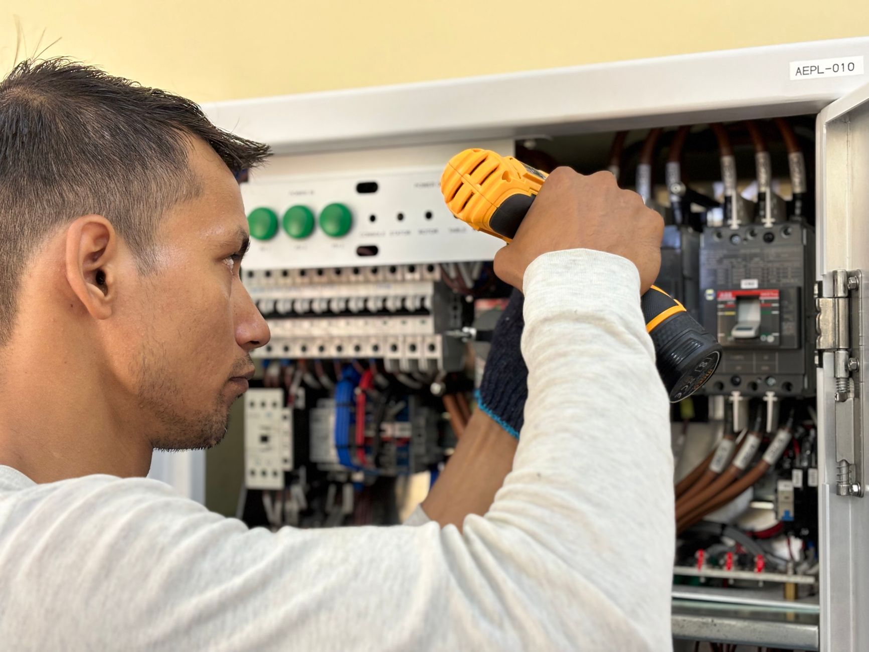 Electrician working on an electrical control panel