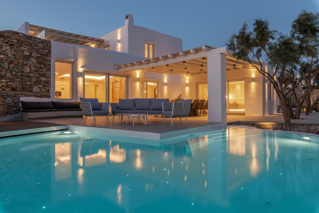 Xenia — Illuminated villa and pool at dusk