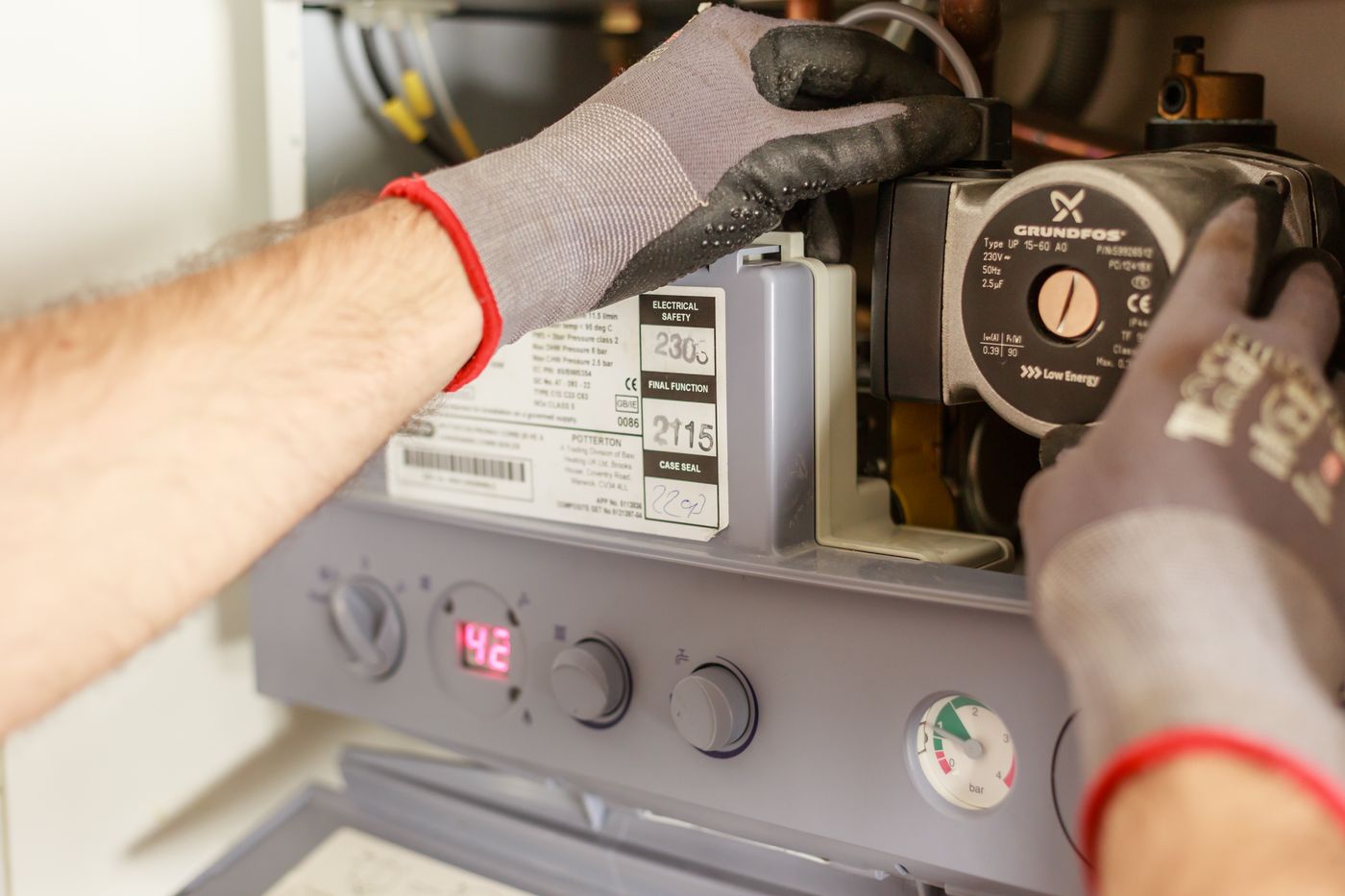 Technician servicing a heating system circulation pump