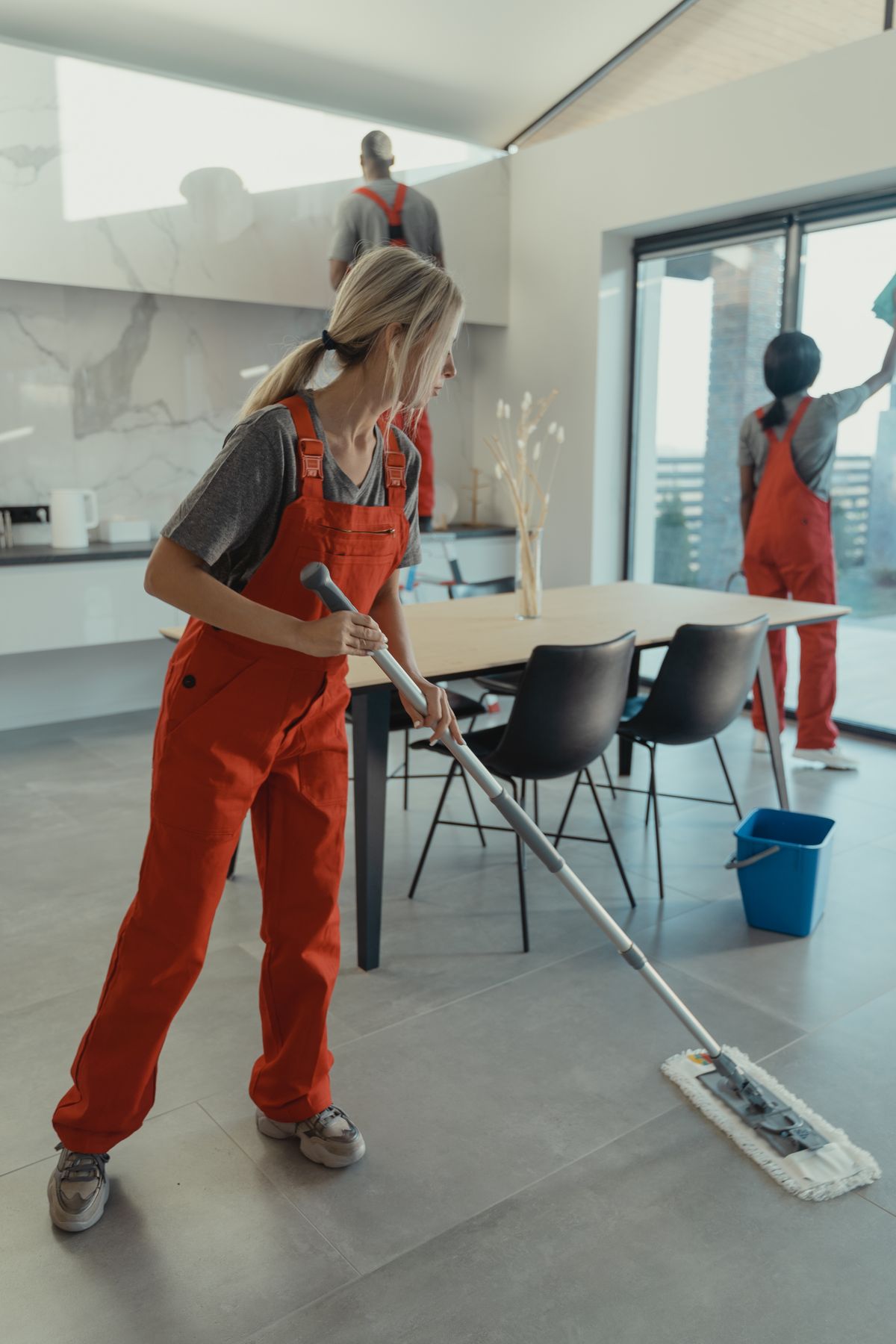 Professional cleaning team cleaning floors and windows